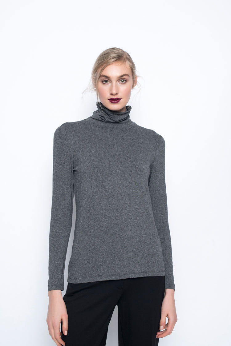 A model wearing the Long Sleeve Turtleneck Top in heather charcoal color.