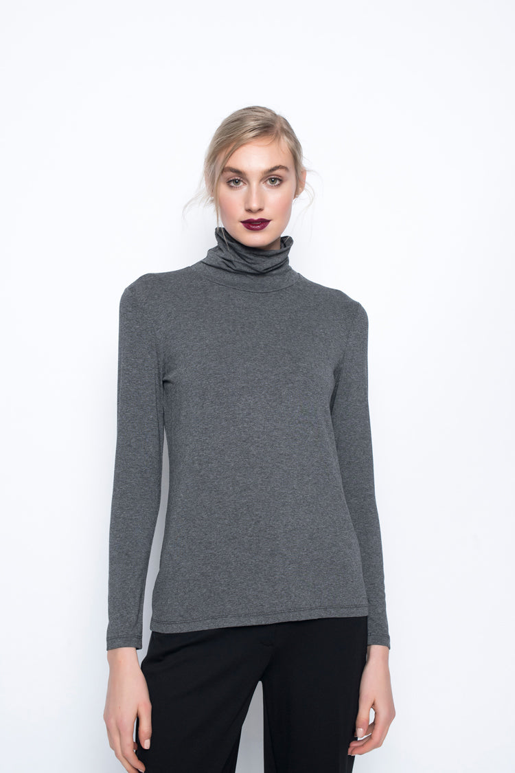 A model wearing the Long Sleeve Turtleneck Top in heather charcoal color. 