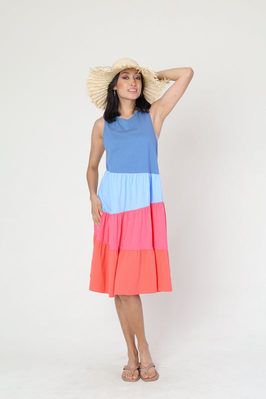 Model is showing the Summer Color Block Dress while wearing a cream-colored straw hat. The dress is available at Kadou Boutique.
