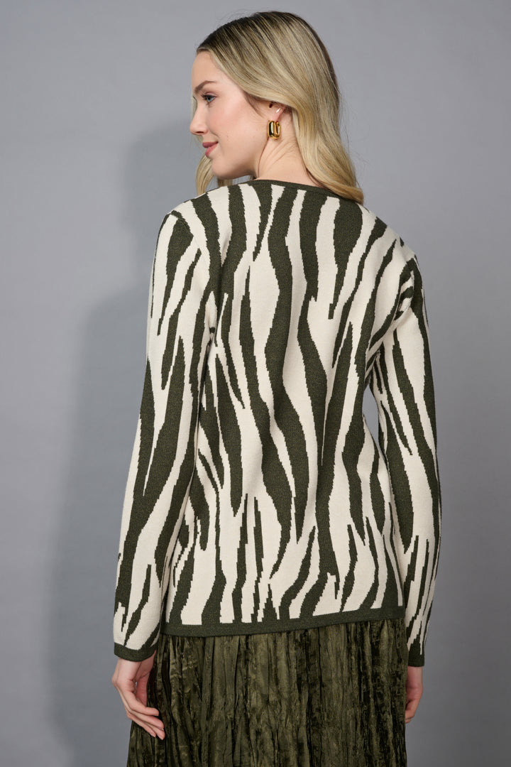 A back view of a woman wearing a zebra pattern sweater against a gray background