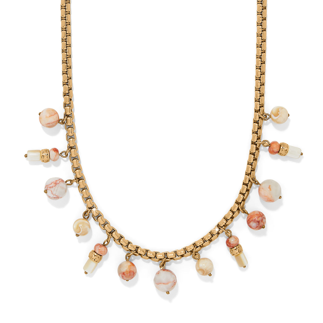 Necklace with gold chain and pink beads on a white background