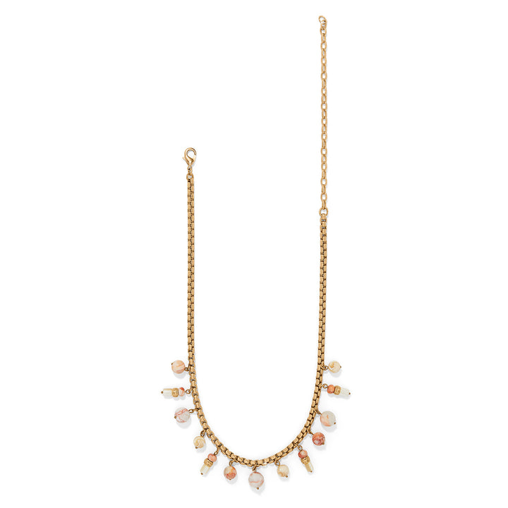 Gold necklace with small pearls on a white background, showing the entire necklace.