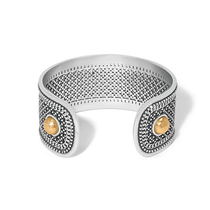 Silver cuff bracelet with gold accents on a white background