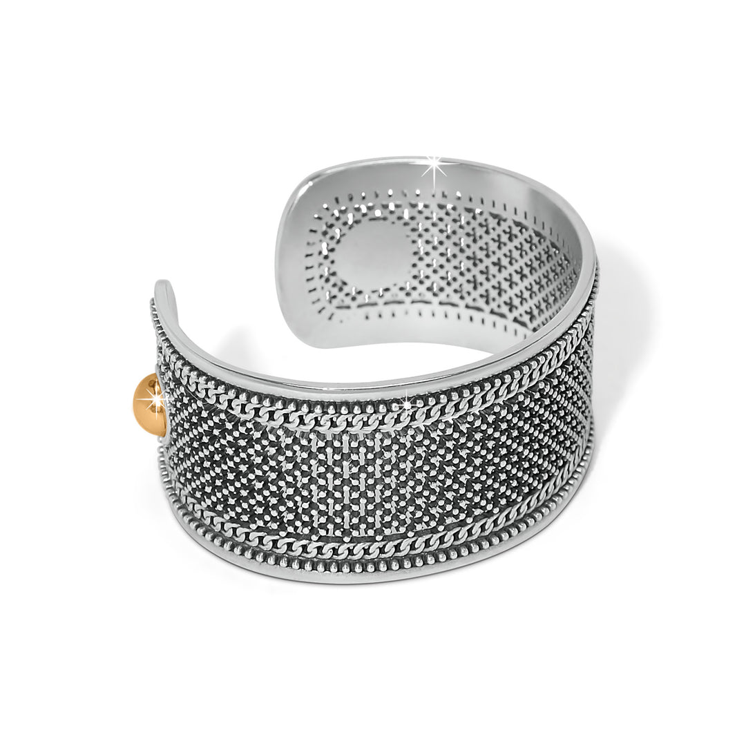 Silver textured ring with a gold accent on a white background, a side view