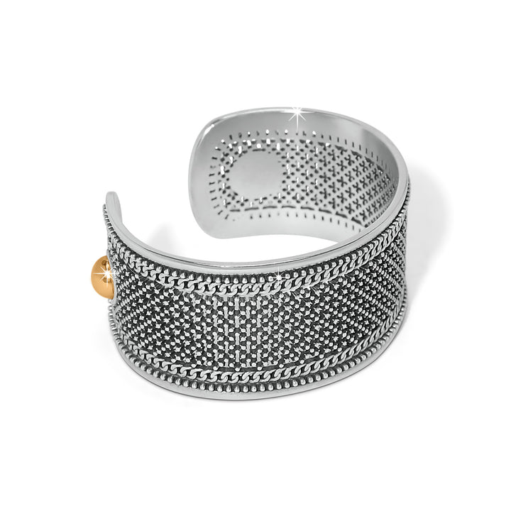 Silver textured ring with a gold accent on a white background, a side view