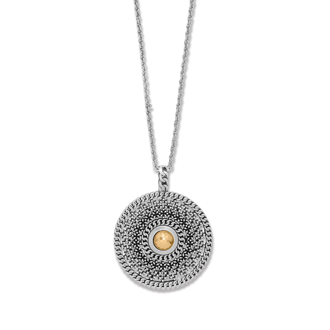 Silver necklace with a circular pendant featuring a gold center on a white background