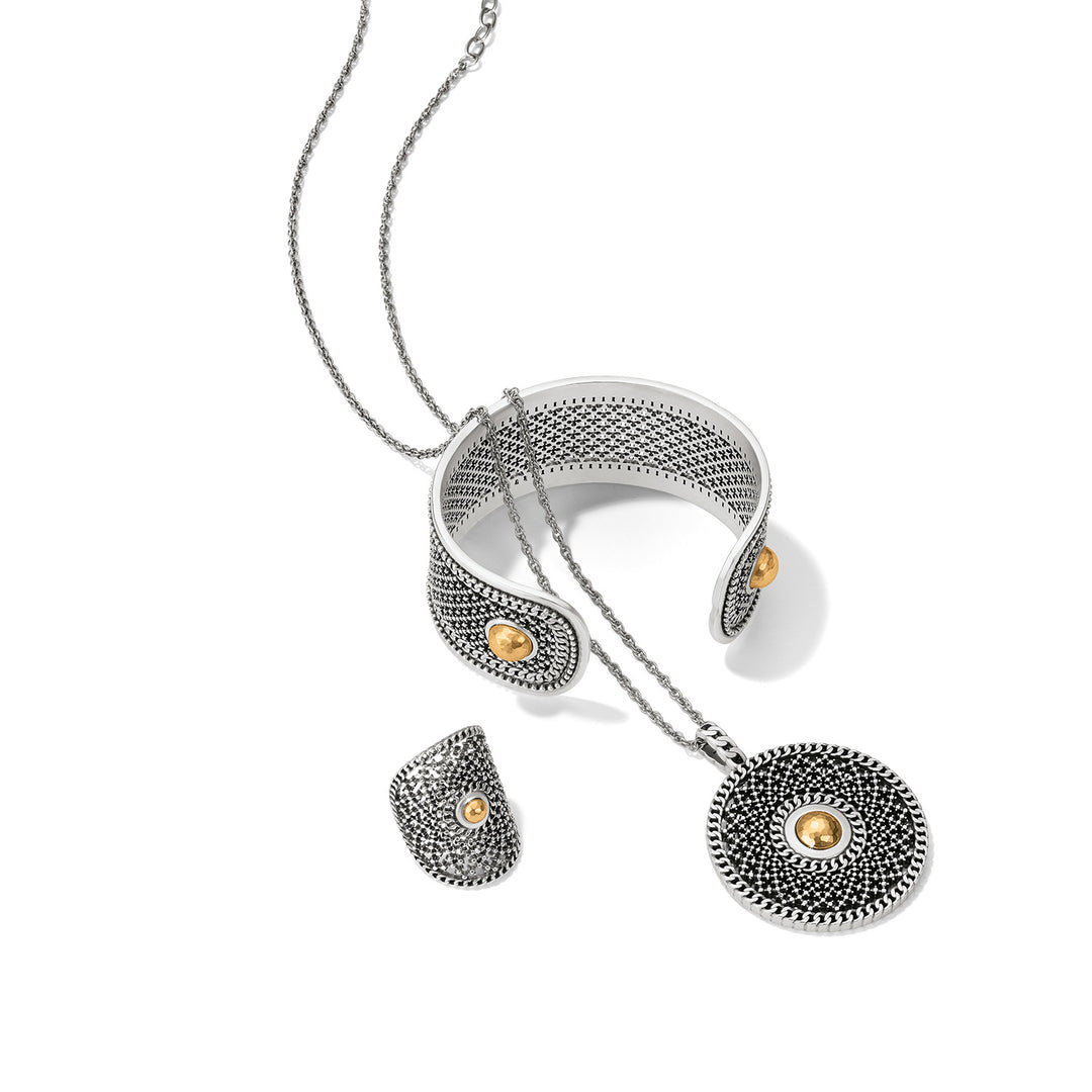 Silver and gold necklace with circular pendants on a white background