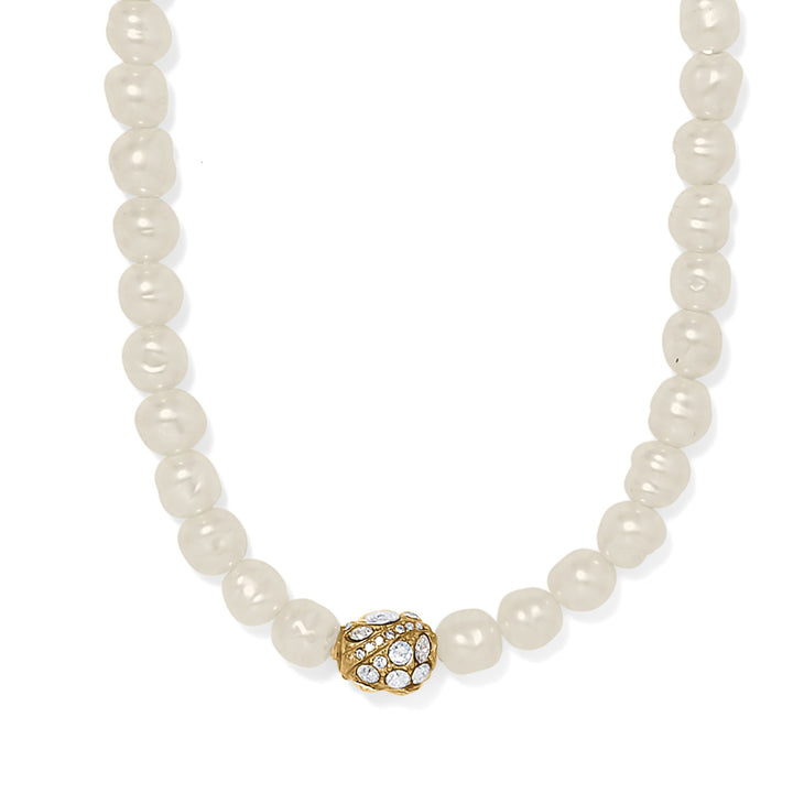 Pearl necklace with a gold and crystal clasp on a white background