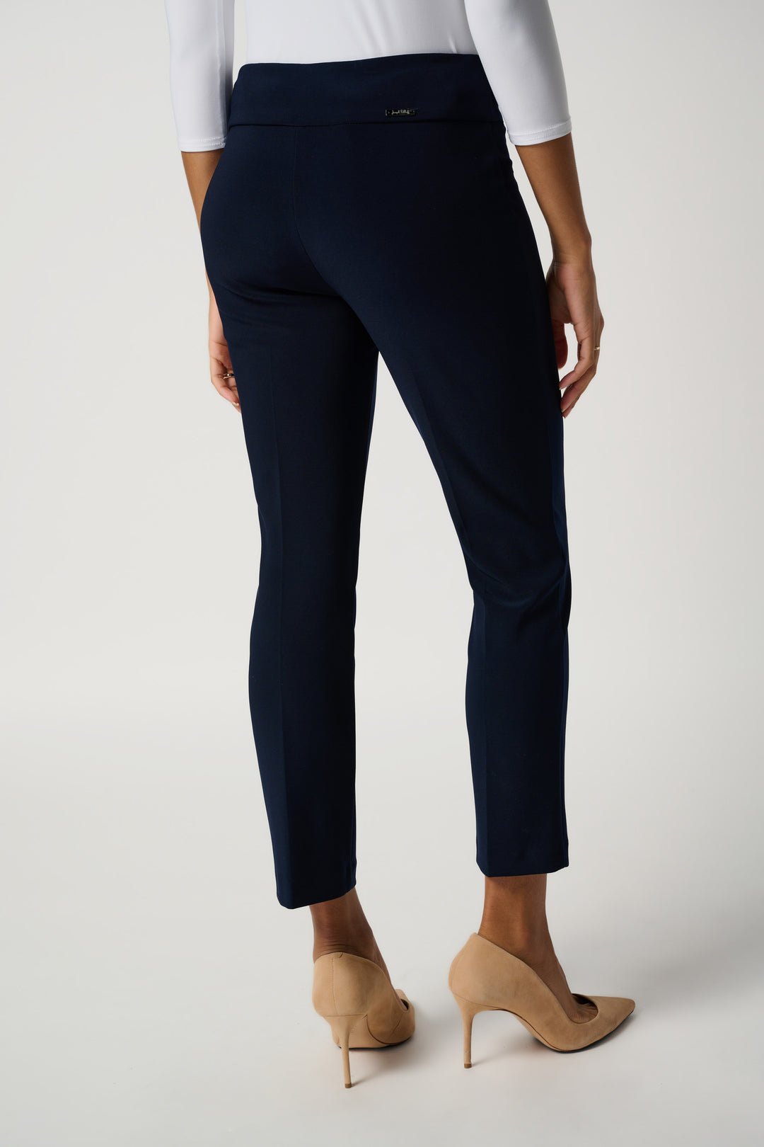 Navy blue pants worn by a person on a white background