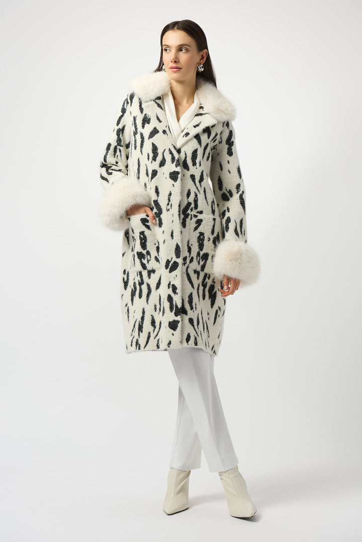 Woman wearing a patterned coat with fur trim on a white background