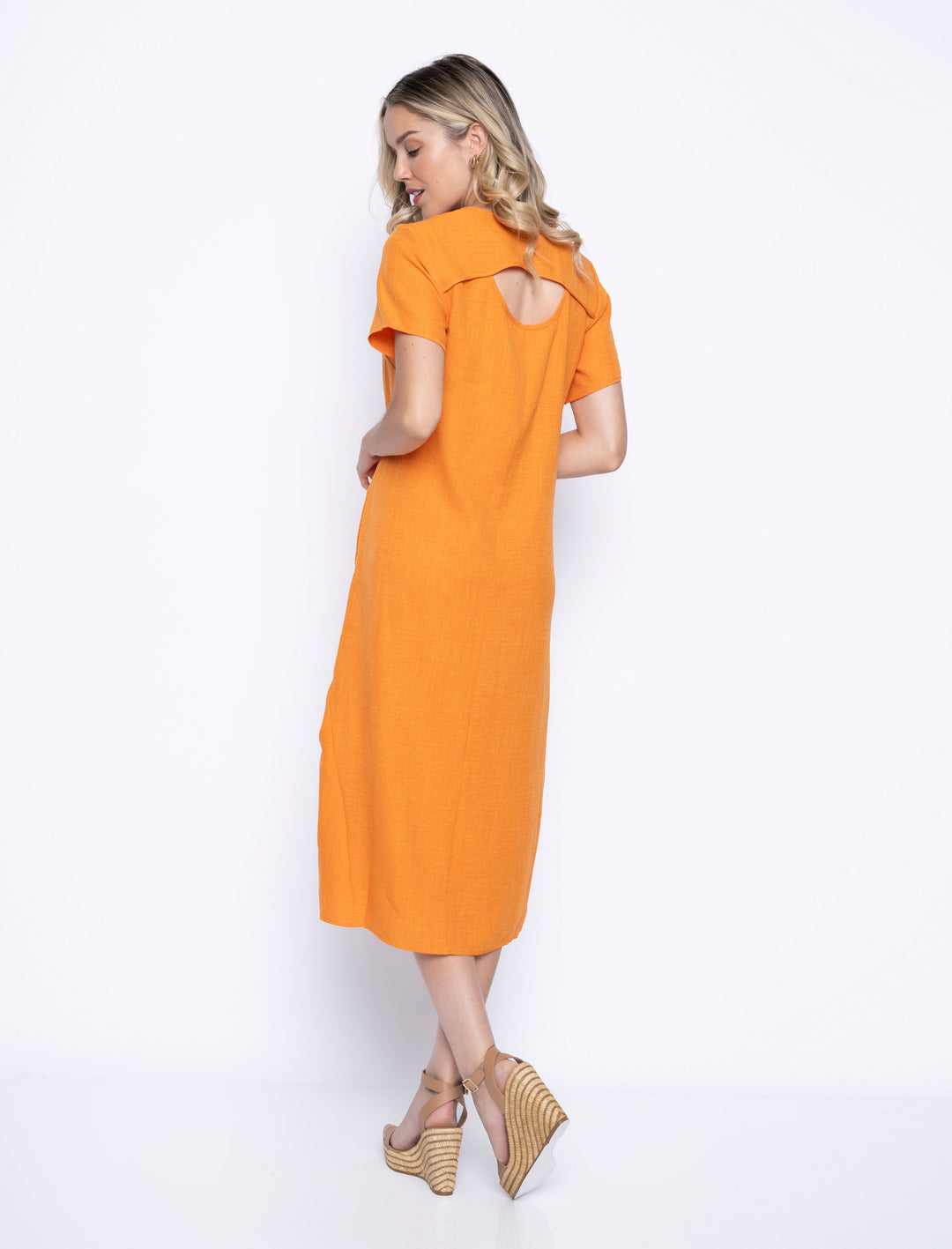 The model is wearing Picadilly Maggy Hi-Lo Midi Dress showing the cutout in the back.