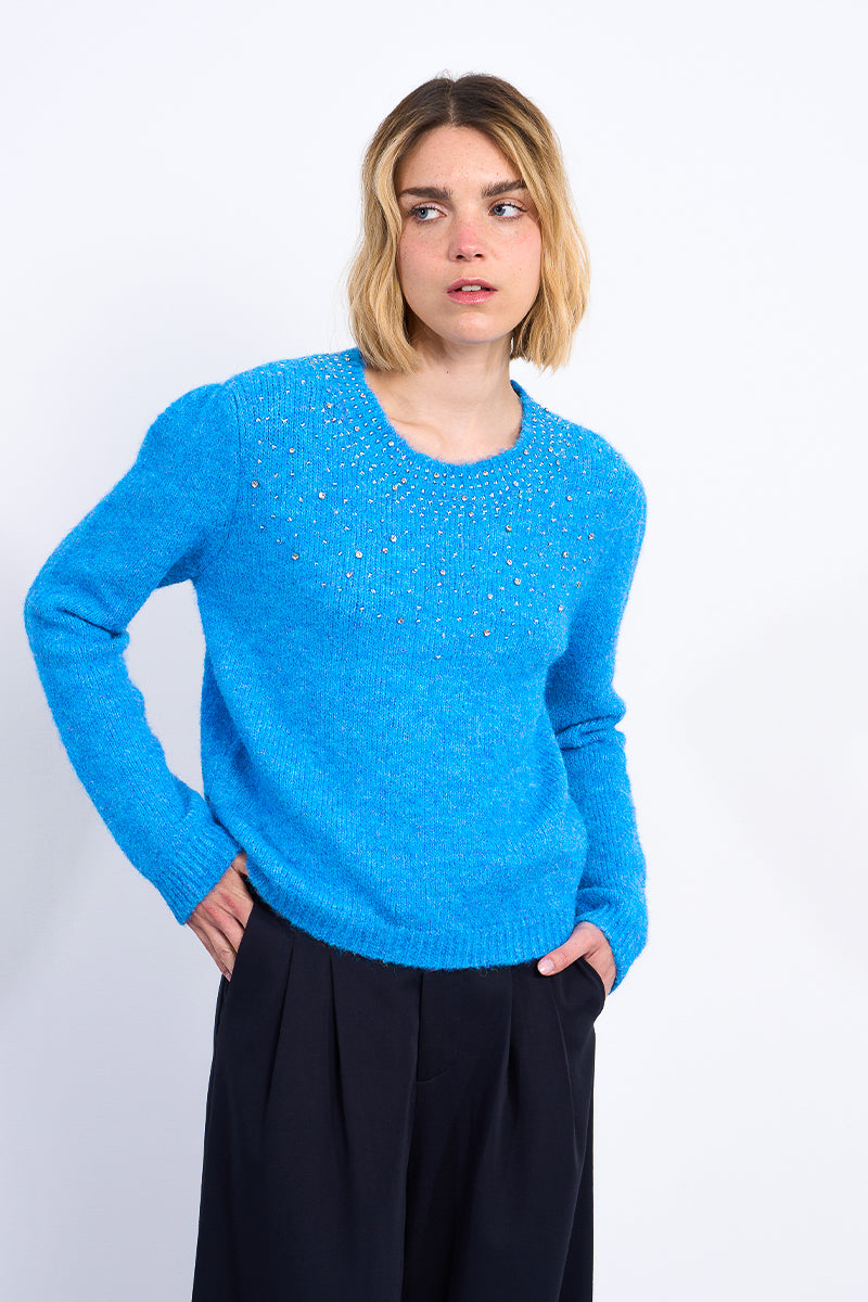 Person wearing a blue sweater on a white background