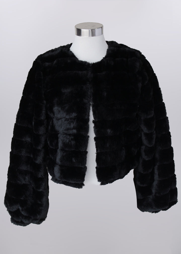 Black fur jacket on a mannequin against a white background