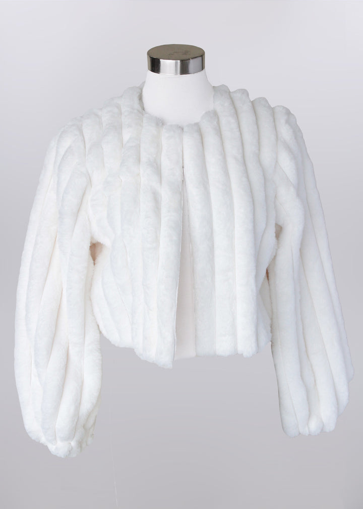 White fur shrug on a mannequin against a plain background