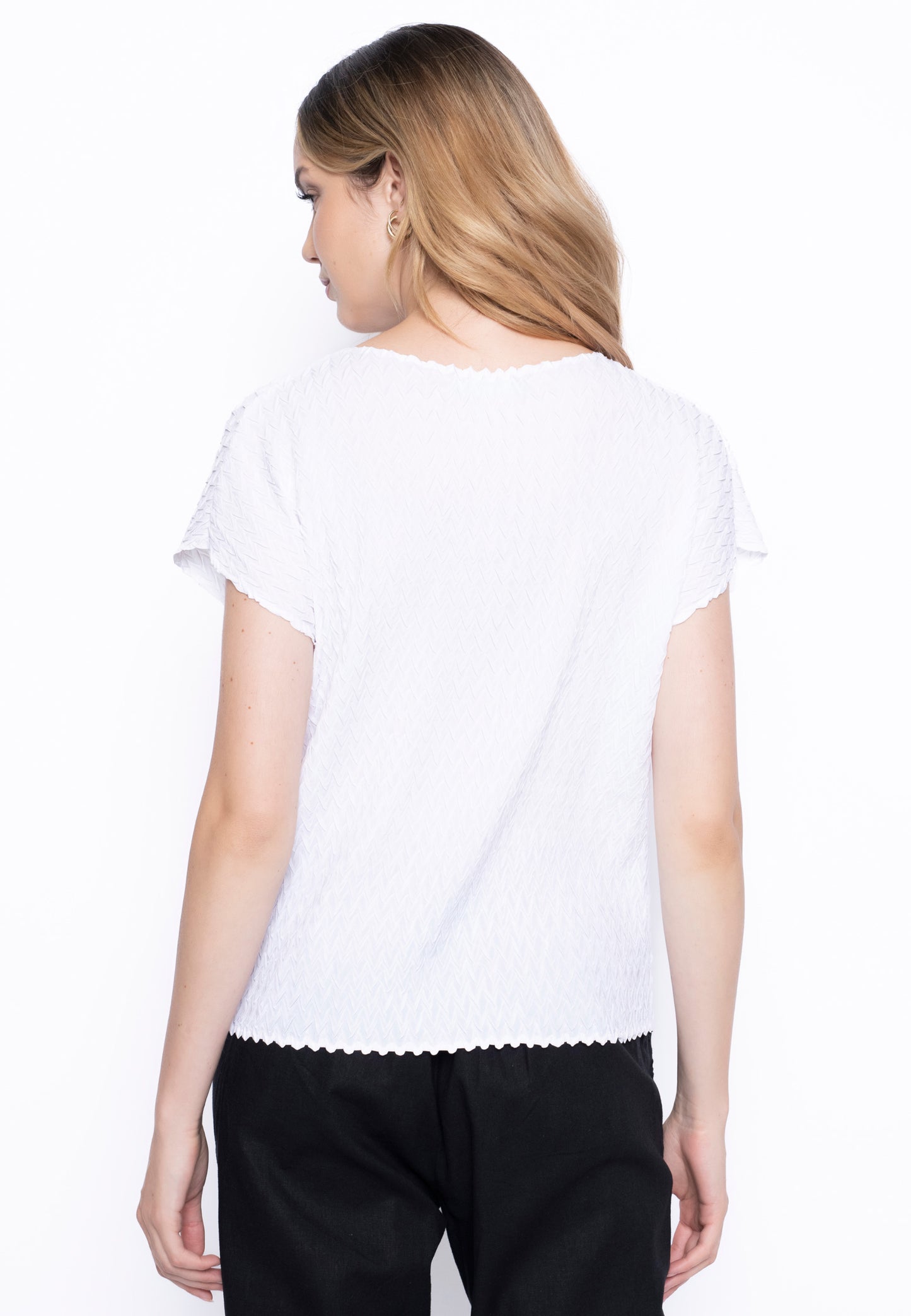 The Short Sleeve Pleated Top in white, a back view.