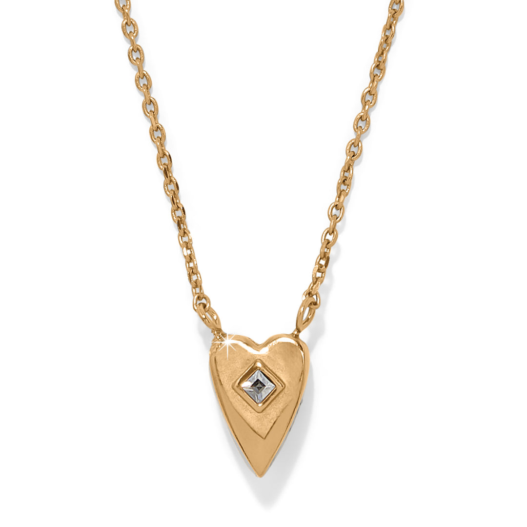 Gold heart-shaped necklace with a diamond on a white background