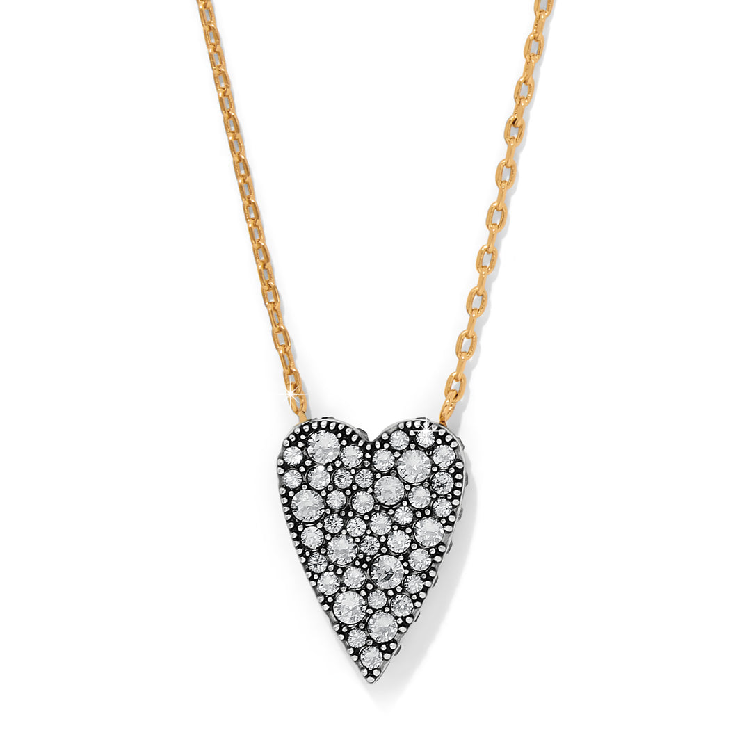Heart-shaped diamond pendant on a gold chain against a white background