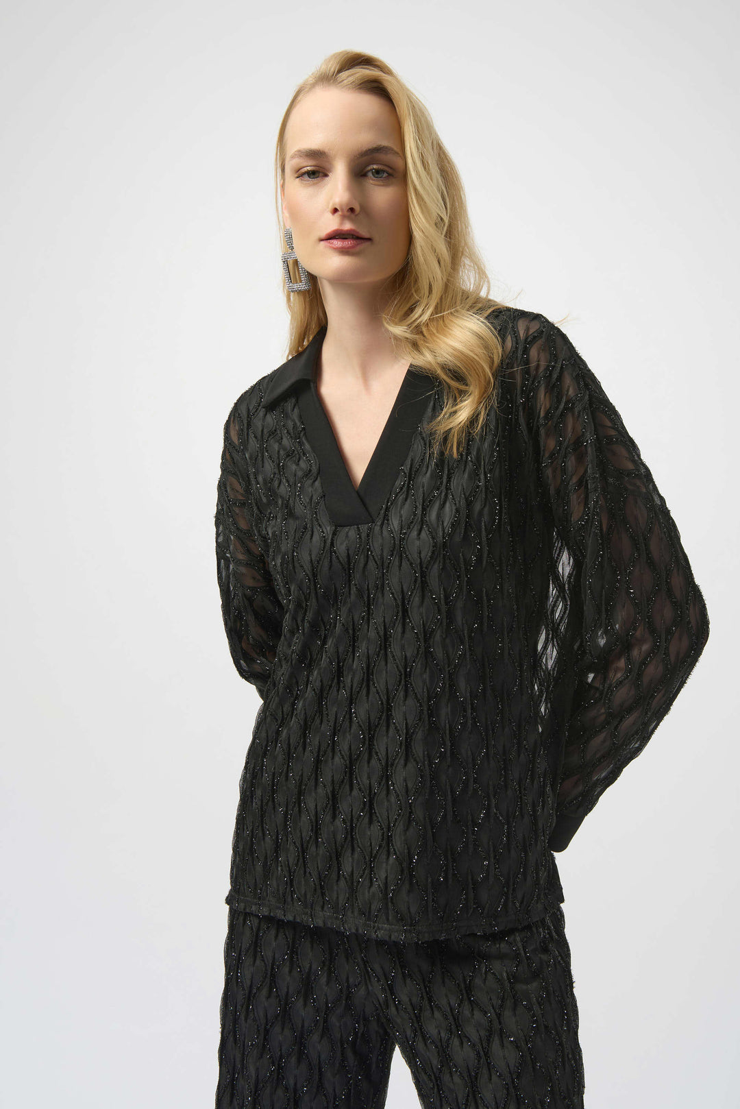 Woman wearing a black textured outfit on a white background