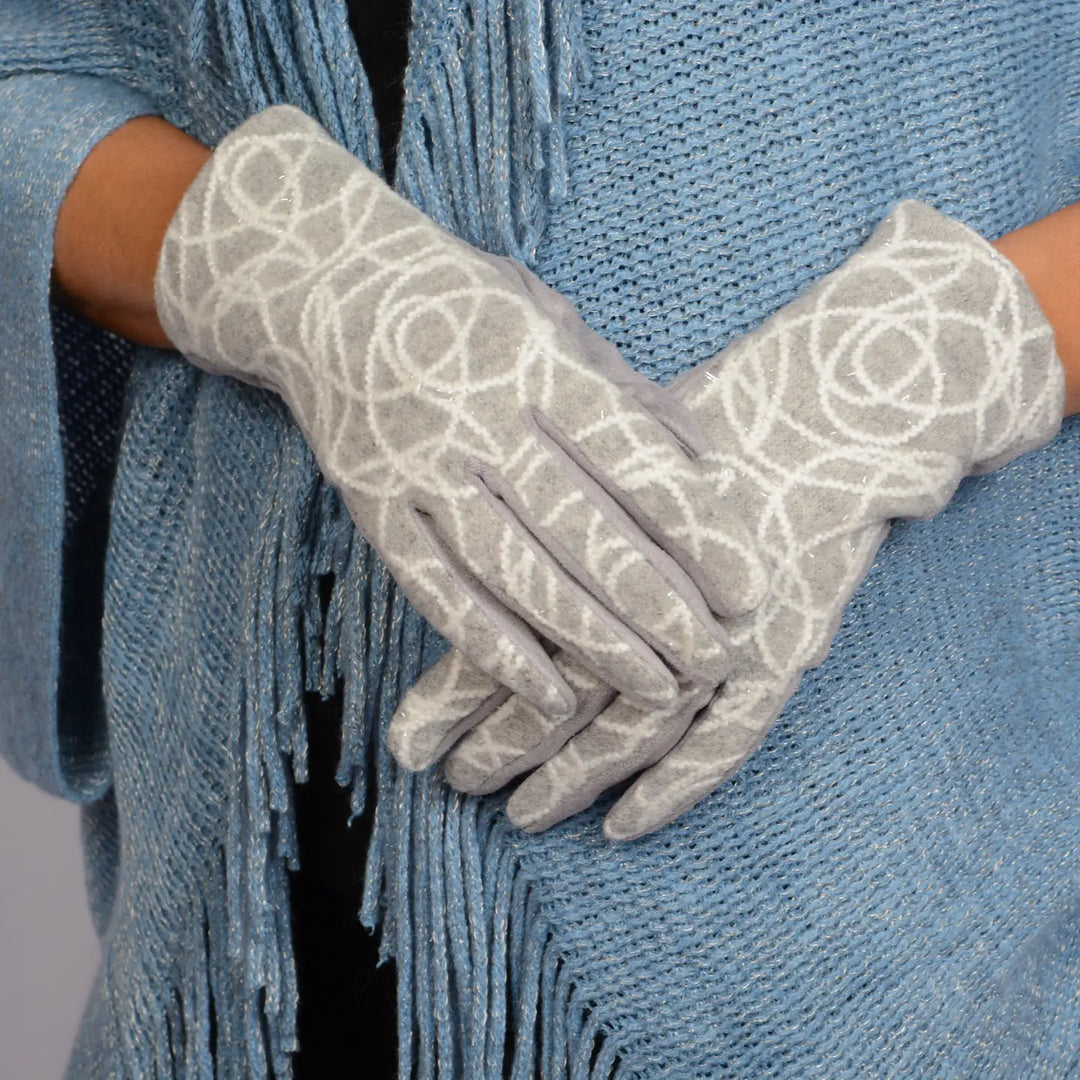 Gray lace gloves worn by a person with a blue textured garment.