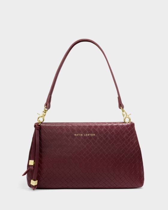 Maroon handbag with gold accents on a light gray background