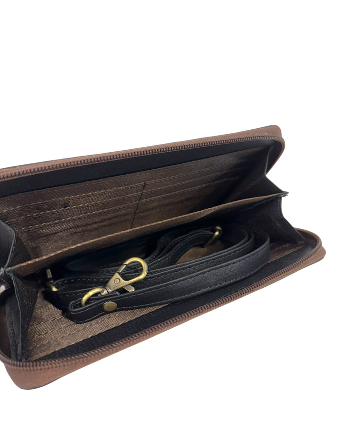 Brown leather clutch with a black interior and gold clasp on a white background