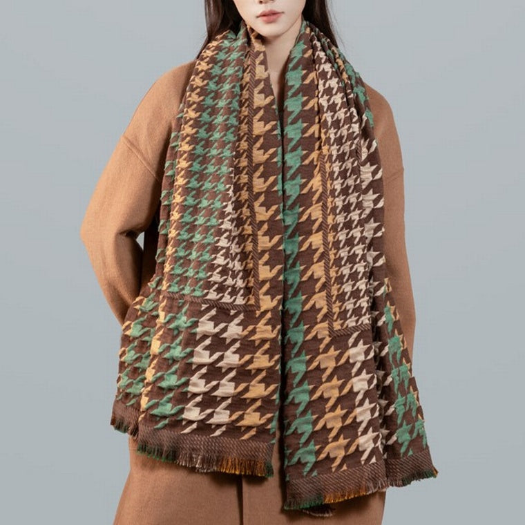 Person wearing a patterned scarf with a plain background