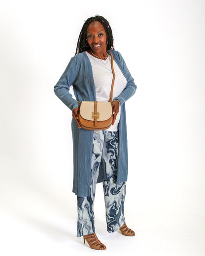 The model is wearing the Ribbed Long Cardigan in Blue color. Shop online or in store.
