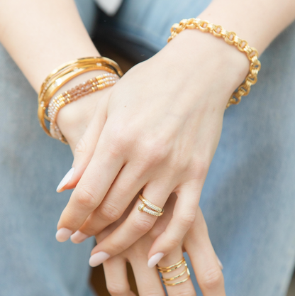 A model wearing the Adjustable Pave Nail Ring in gold.