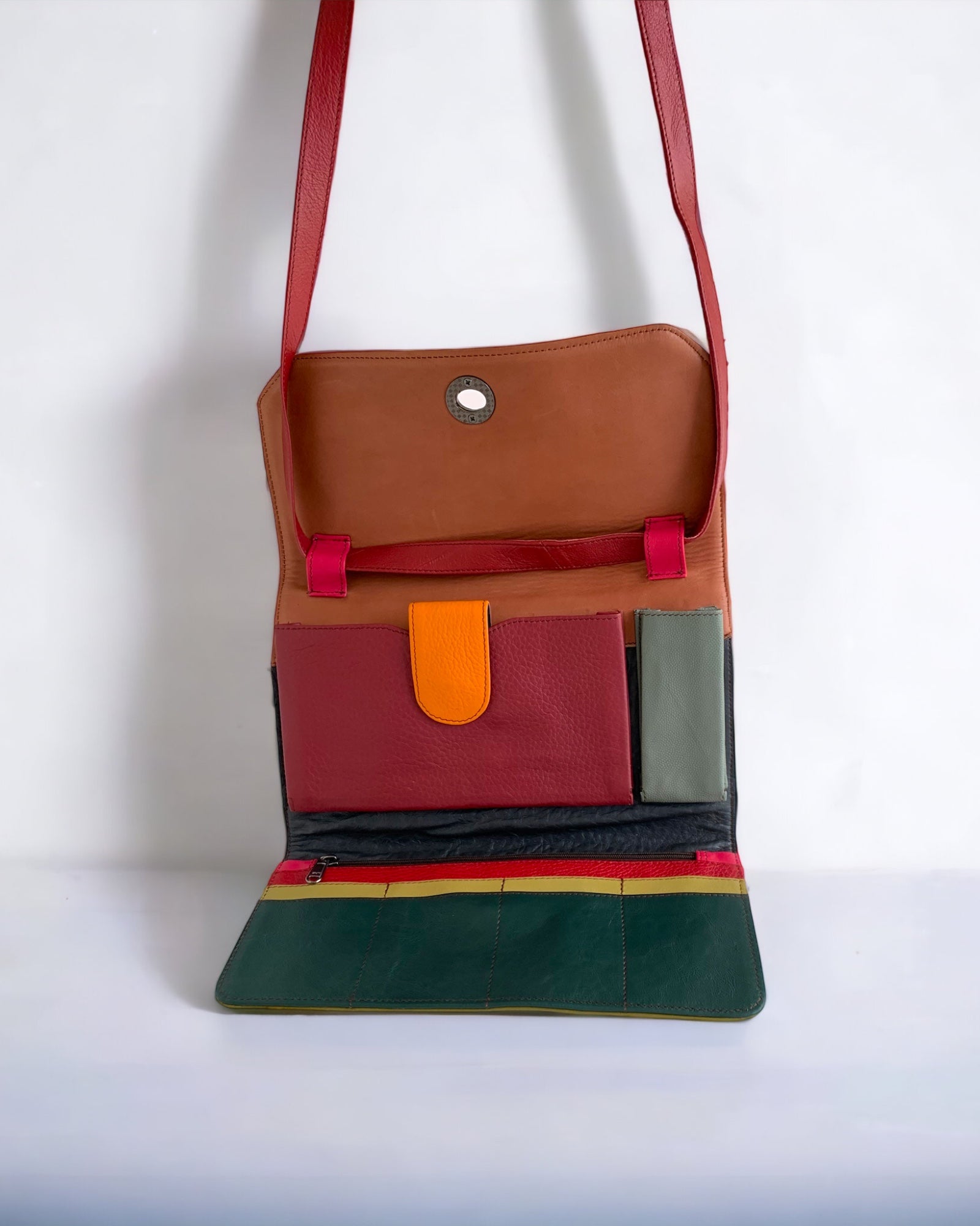The Soruka Multi-Function Purse. Available at Kadou Boutique with Free Shipping. The green and orange purse from inside. Showing the phone pocket, the essentials pocket, the 8 credit cards slots and the zipper pocket.