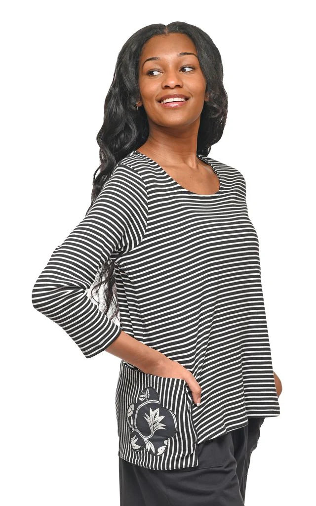 Woman wearing a black and white striped shirt with a floral design on a white background