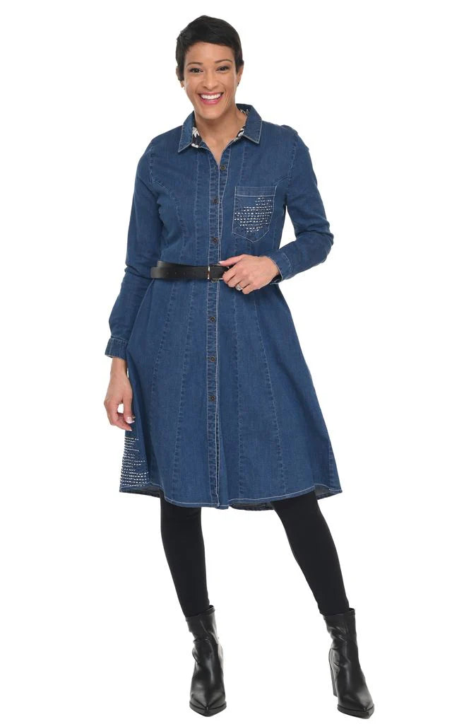 Woman wearing a blue denim dress with a belt and black boots on a white background
