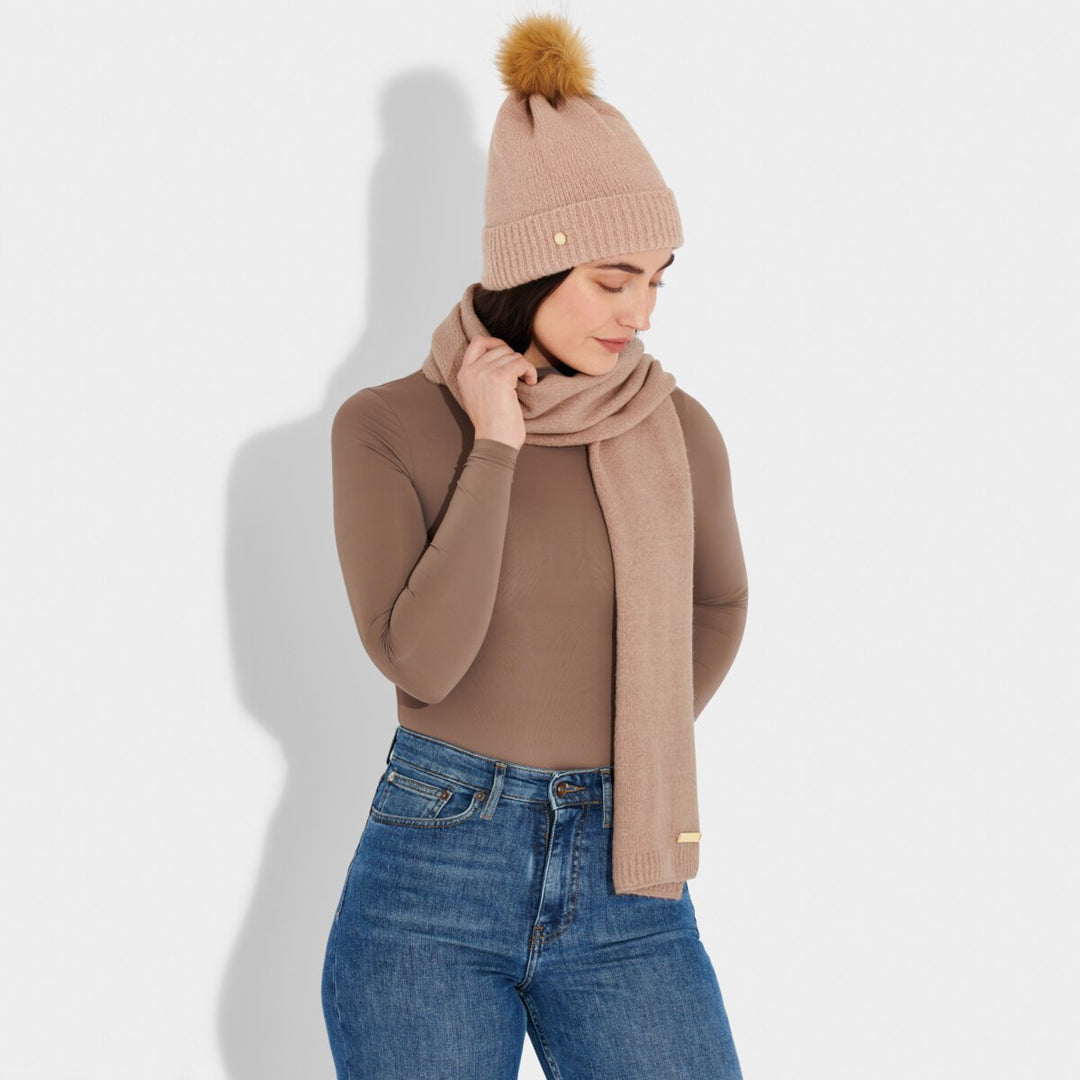 A model wearing the Knitted Hat and Scarf Set in Dusty Pink.