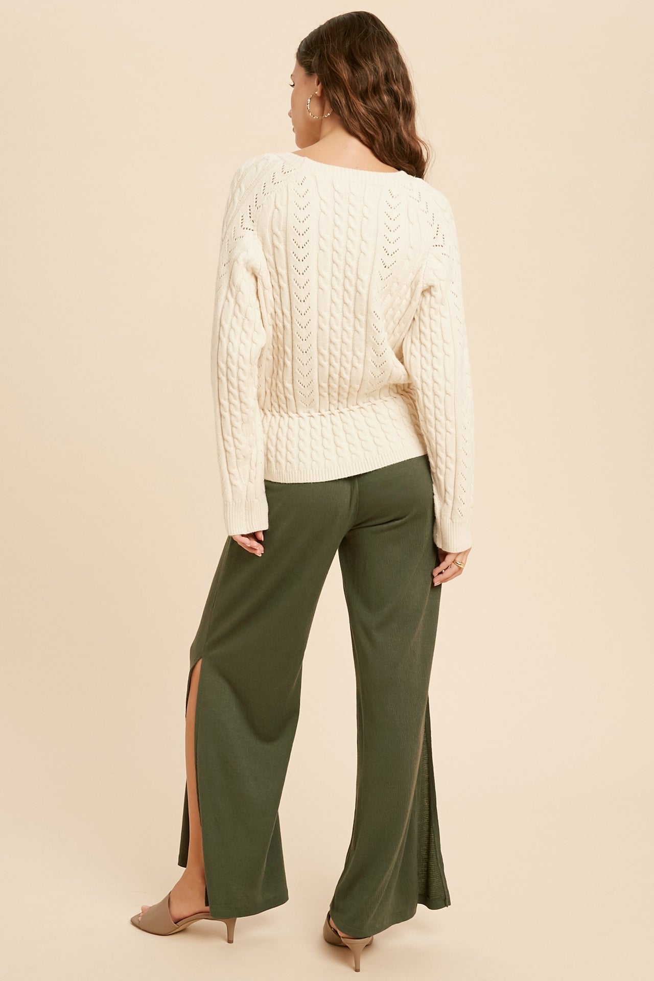 Cable Knit Drawstring Long Sleeve Sweater in cream color. Back view.