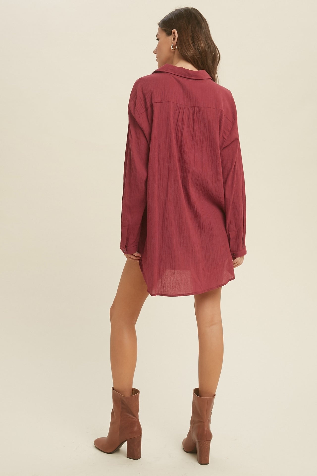 Showing a model wearing the Button Down Tunic Top in sienna color. A back view.