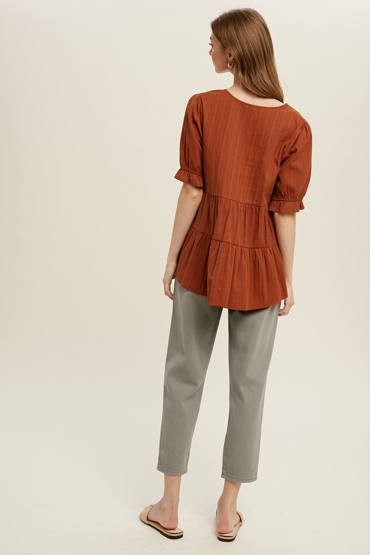 Babydoll Woven Top in Brick color. Back view.