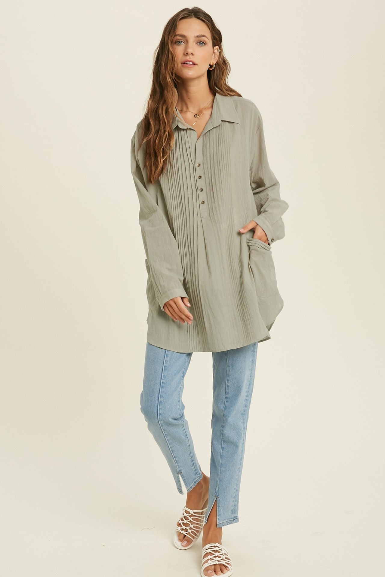 Showing a model wearing the Button Down Tunic Top in sage color.