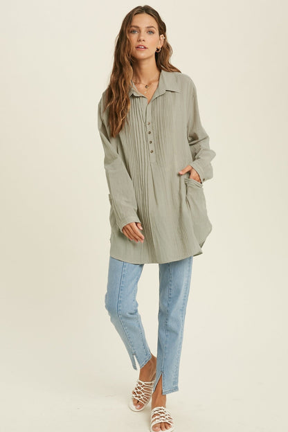 Showing a model wearing the Button Down Tunic Top in sage color.