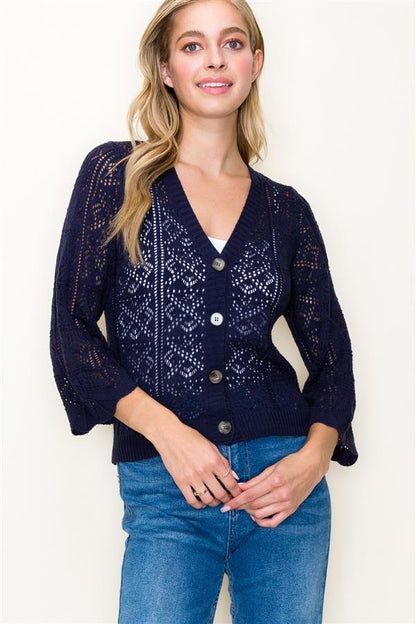 Crochet Cardigan in navy blue color. Showing the  buttoned up cardigan  with the 3/4 sleeves.