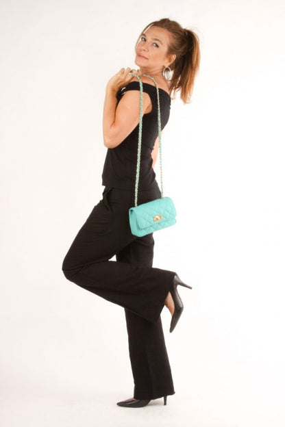 A model is holding the Quilted Small Leather Bag on her shoulder. 