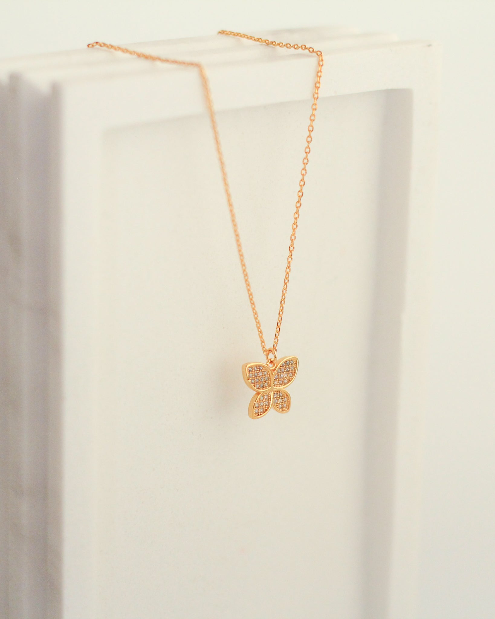 Rounded Wing Pave Butterfly Necklace hanging.