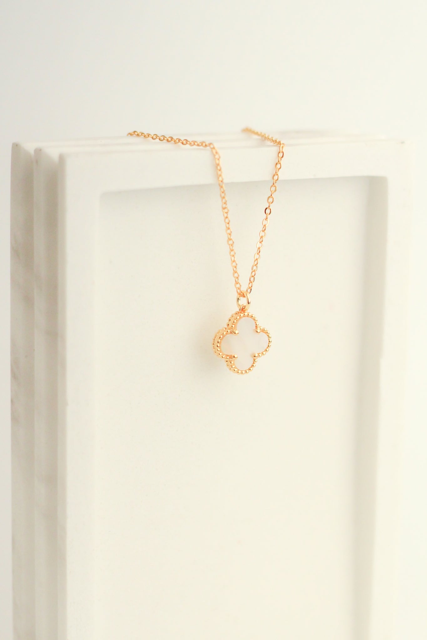 Another image showing the Mother of Pearl Clover Top Loop Necklace, a farther view. 