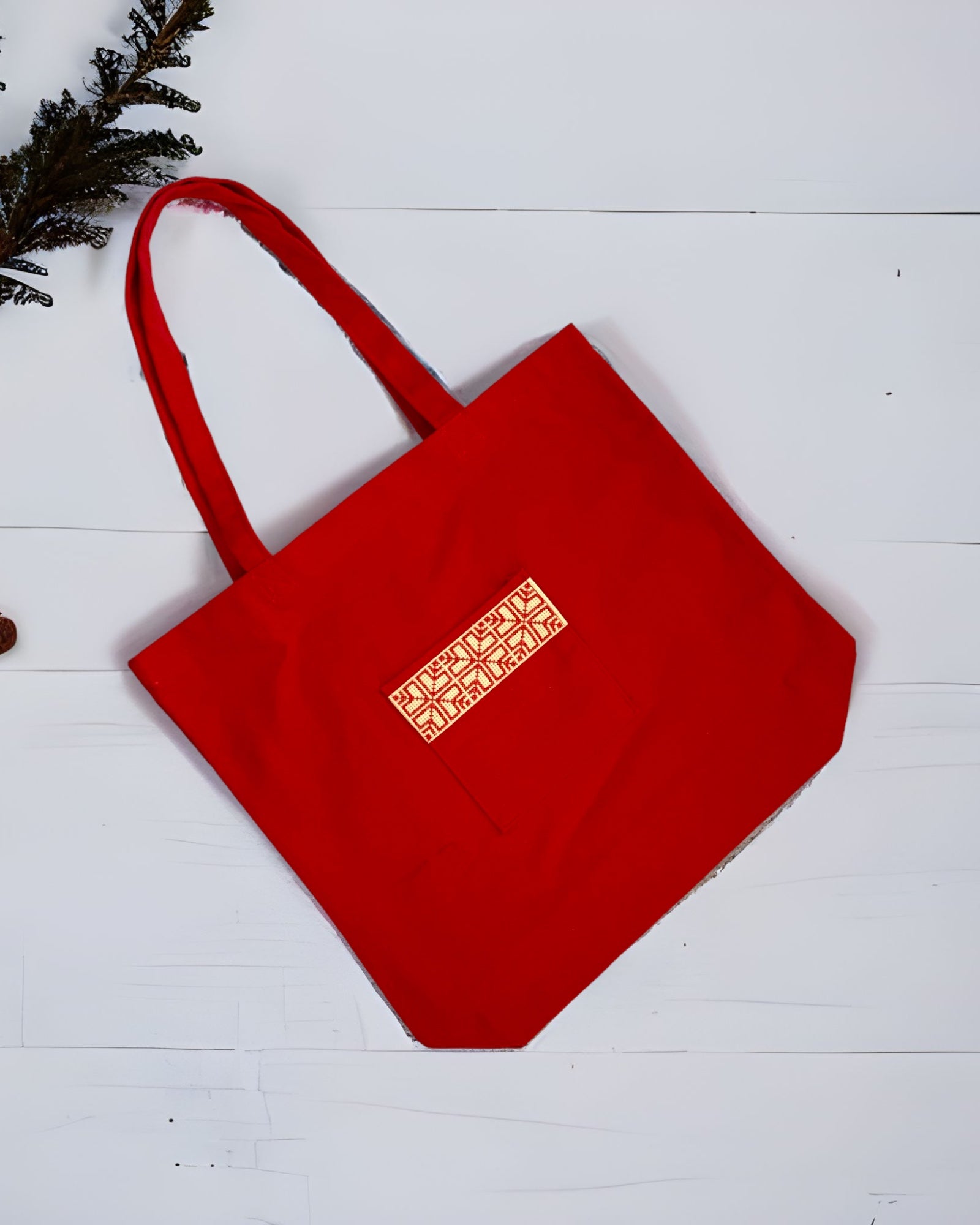 Tatreez Fabric Tote Bag in Red color and Red embroidery on the outside pocket.