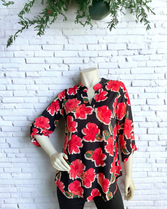 The photo is showing a manikin wearing the Red Peony Top over black leggings. Available at KADOU Boutique with free shipping.