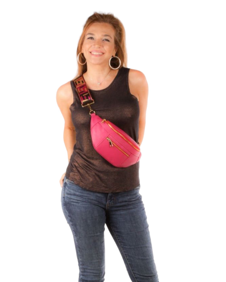 A model  wearing the Leather Fanny Pack in hot pink. 